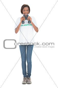 Smiling volunteer woman using binoculars