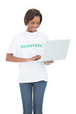 Happy volunteer woman using laptop