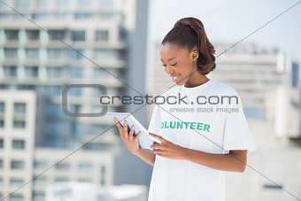 Woman wearing volunteer tshirt using tablet pc