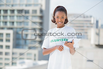 Smiling volunteer holding tablet pc
