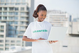Happy volunteer using laptop