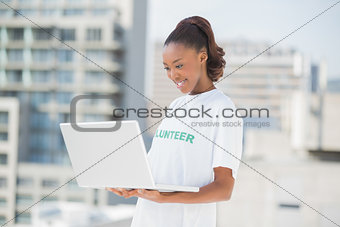 Smiling woman looking at her laptop