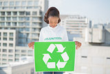Pretty volunteer woman holding recycling sign