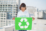 Cute volunteer woman holding recycling sign