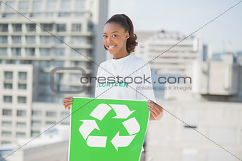 Happy altruist woman holding recycling sign