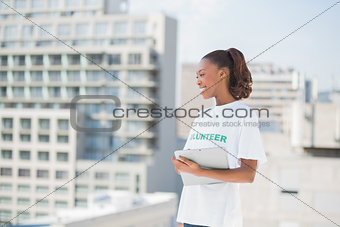 Cheerful volunteer woman holding clipboard