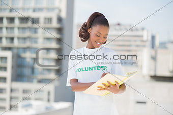 Happy altruist woman writing on notebook