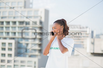 Cheerful altruist woman on the phone covering her ear
