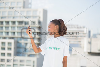 Cheerful altruist woman looking at her mobile phone