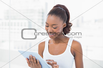 Cheerful sporty model using tablet pc