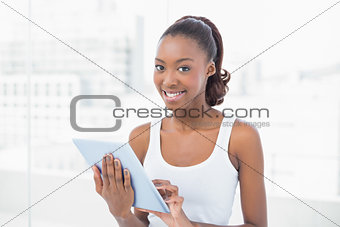 Happy sporty model holding tablet pc