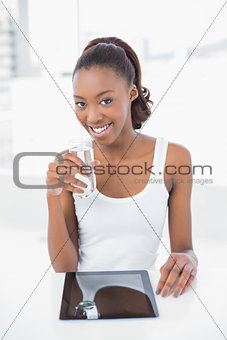 Happy sporty model holding glass of water