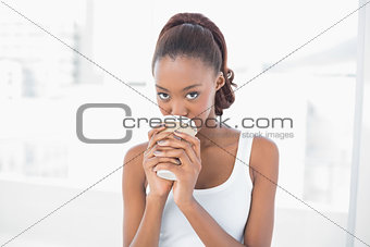 Cute sporty model drinking coffee