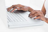 Close up on womans hands using her laptop