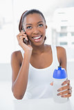 Smiling athletic woman having a phone call