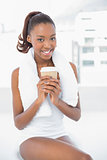 Smiling athletic woman holding coffee