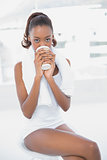 Attractive athletic woman holding coffee