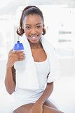Attractive athletic woman holding flask