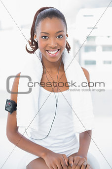 Smiling athletic woman listening to music