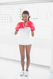 Slender athletic woman wearing boxing gloves