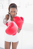 Slender athletic woman boxing