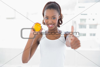 Sporty woman giving thumbs up to camera