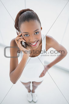 High angle view of happy fit woman on the phone