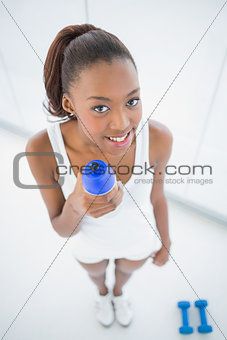 High angle view of relaxed fit woman holding flask