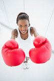 High angle view of smiling fit woman with red boxing gloves