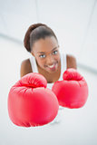 High angle view of happy fit woman with red boxing gloves