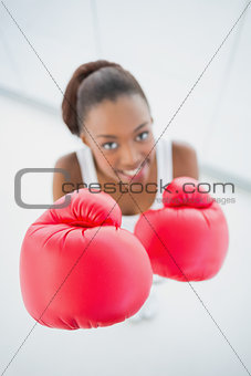 High angle view of happy fit woman with red boxing gloves