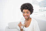 Happy gorgeous brunette holding glass of water