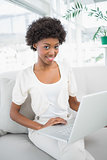 Cheerful gorgeous woman using laptop