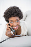 Happy gorgeous brunette answering the phone
