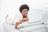 Happy pretty brunette using her laptop