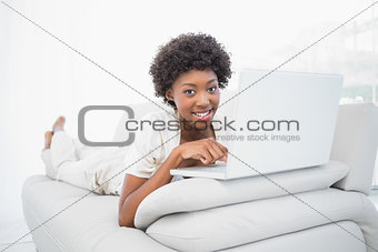 Happy pretty brunette using her laptop