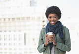 Happy casual woman holding coffee