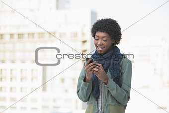 Cheerful casual model texting