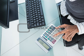 Close up on businesswoman using calculator