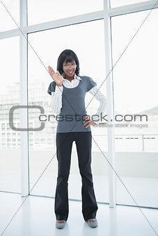Smiling businesswoman waving