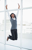 Happy businesswoman jumping