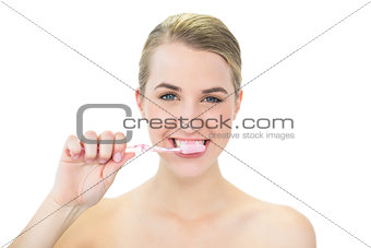 Attractive blonde brushing her teeth