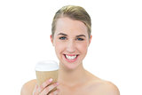 Smiling attractive blonde holding mug of coffee