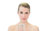 Content attractive blonde holding glass of water