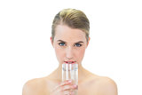 Content attractive blonde drinking water