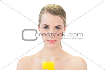 Attractive blonde holding glass of orange juice