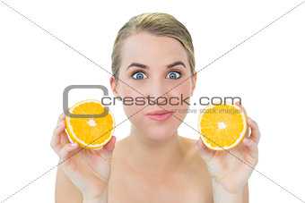 Funny attractive blonde holding orange slices