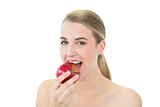 Attractive blonde eating red apple