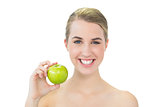 Smiling attractive blonde holding green apple