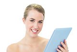 Smiling attractive blonde using tablet pc